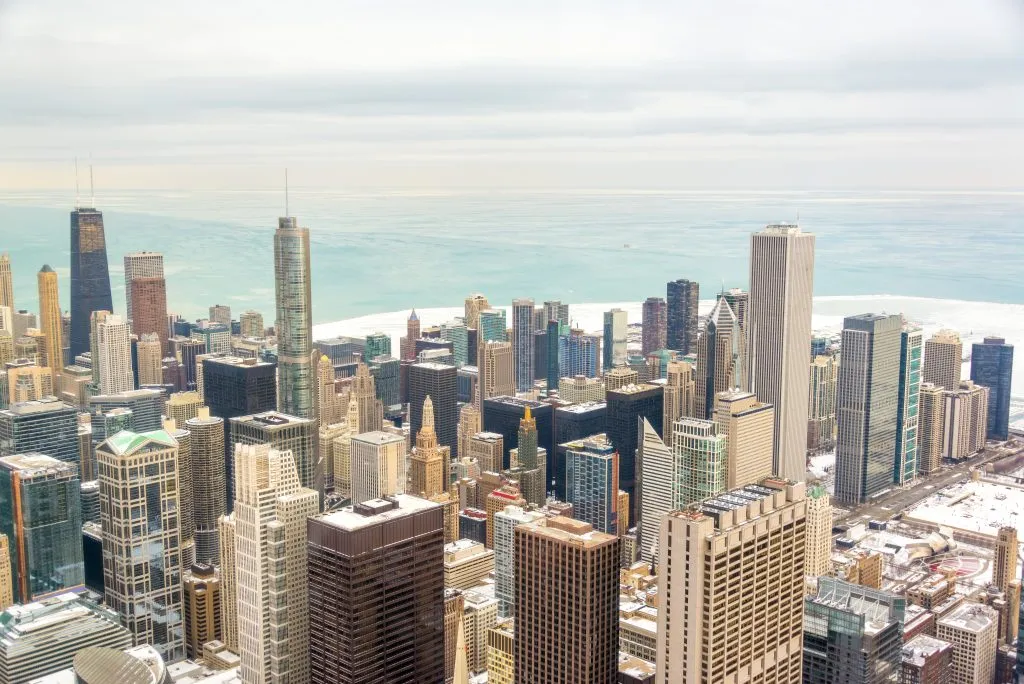 skyline of chicago in winter with lake visible in the distance