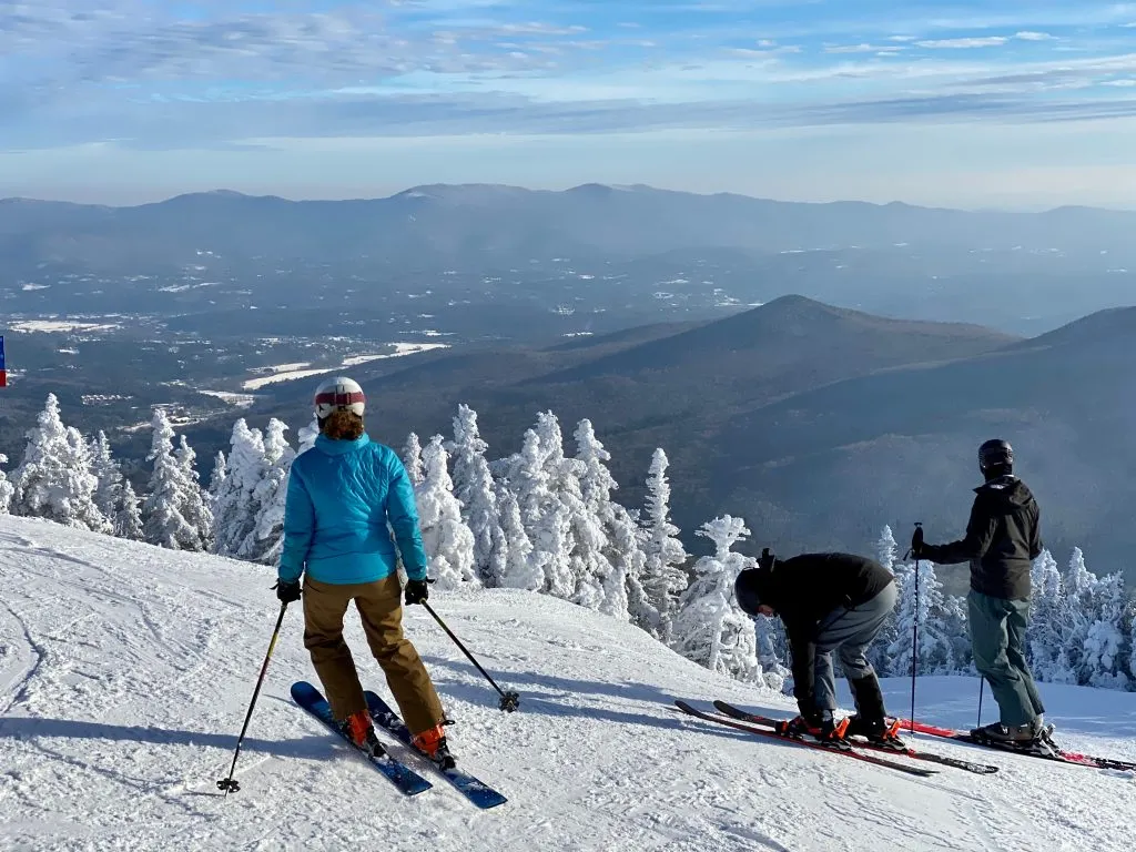 3 skiers on a mountain in vermont, one of the best places to visit in winter in usa