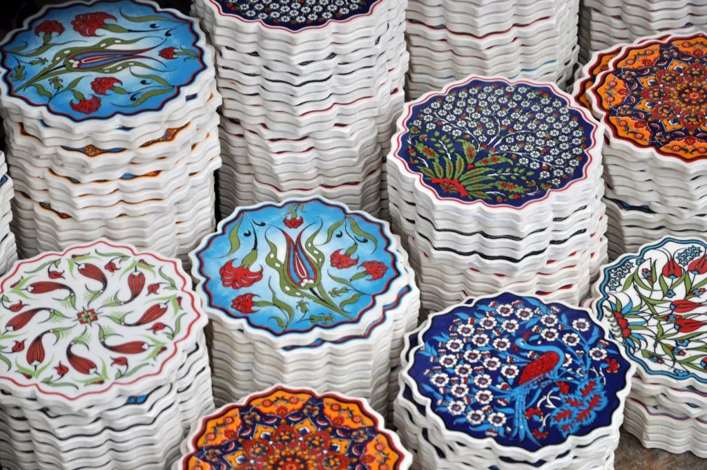 stacks of coasters for sale in a market, a fun option for souvenirs from traveling to collect