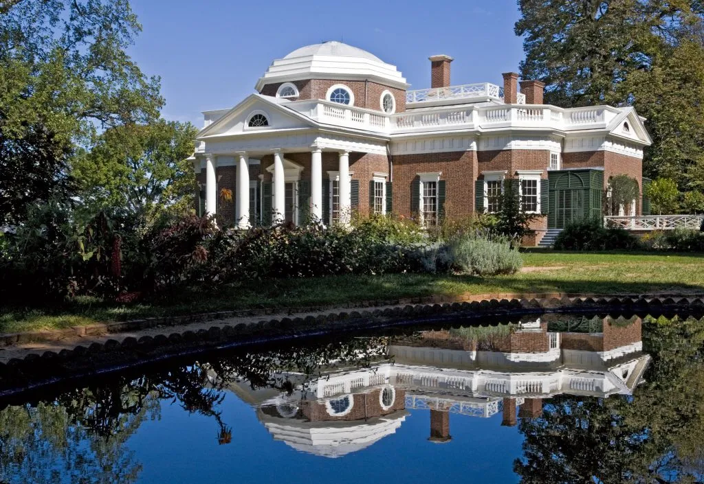 front facade of monticello with reflecting pond in the foreground, one of the best places to visit in virginia