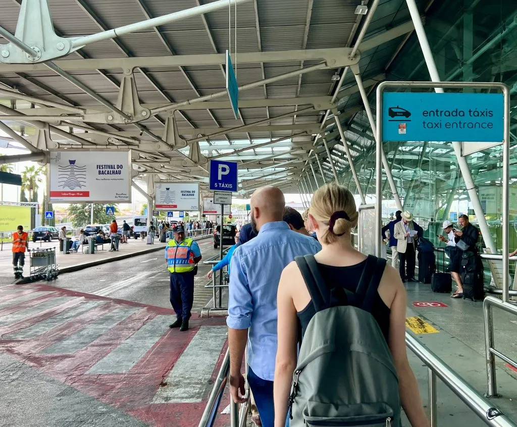 line for taxi stand at lisbon airport arrivals, one of the best lisbon travel tips is that taxis are the easiest way into the city