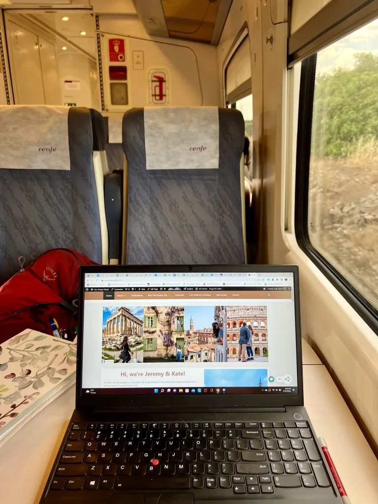 laptop open to our escape clause on renfe train in spain itinerary