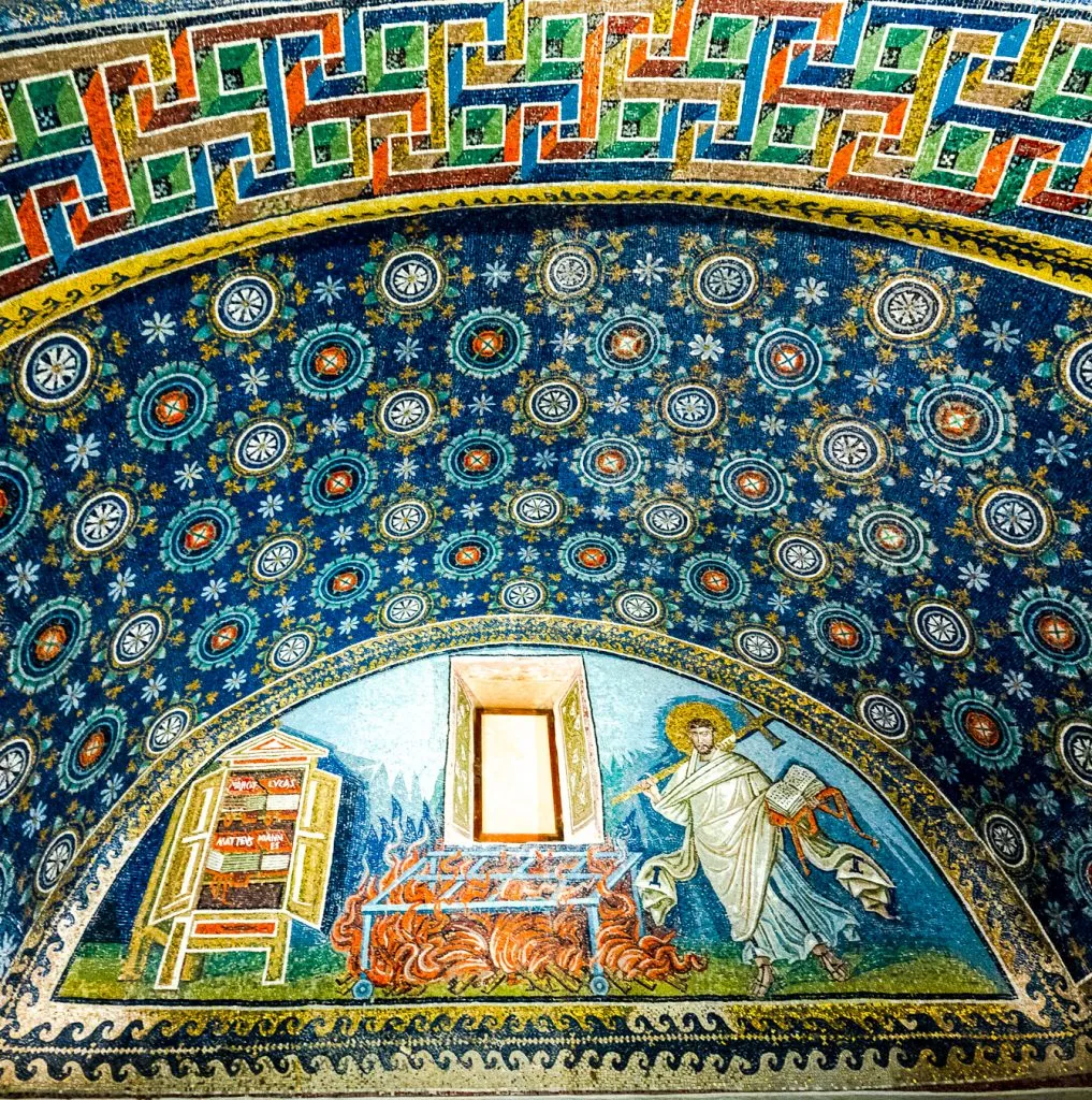 intricate mosaics with a blue backdrop in the Mausoleum of Galla Placidia, seen when visiting mosaics of ravenna italy