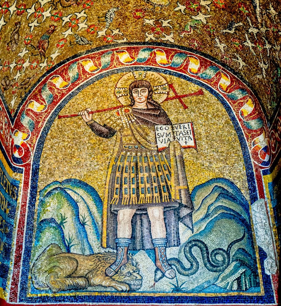 close up of one of the mosaics of ravenna with a man stepping on a lion and a snake