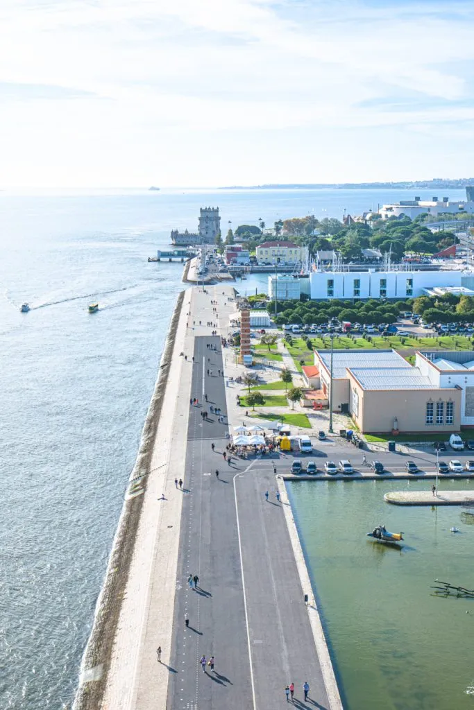 view of the belem tower and tagus river from the monument to the discoveries, one of the best places to visit belem lisbon