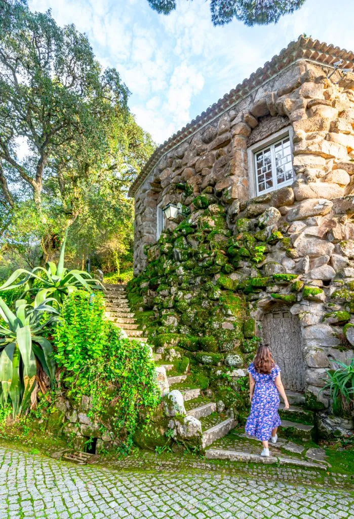 kate storm walking to a stonr building in sintra portugal