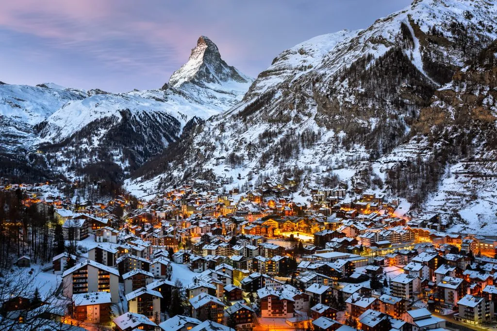 view of zermatt from above at dusk with matterhorn in the background, one of the best places to visit in switzerland