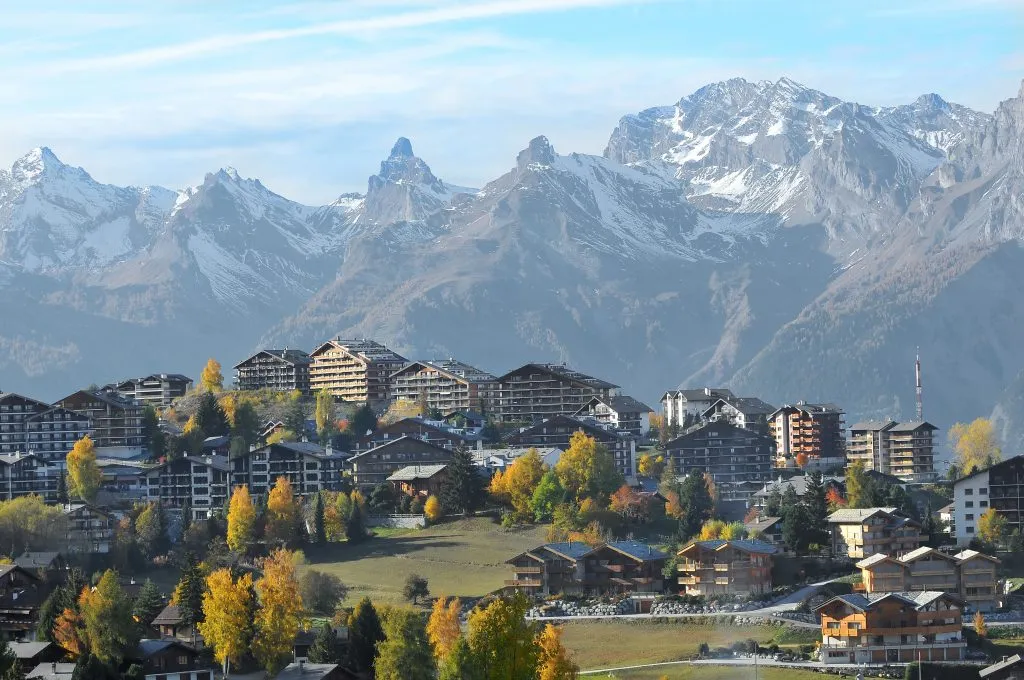 nendaz switzerland with bernese alps looming behind the town