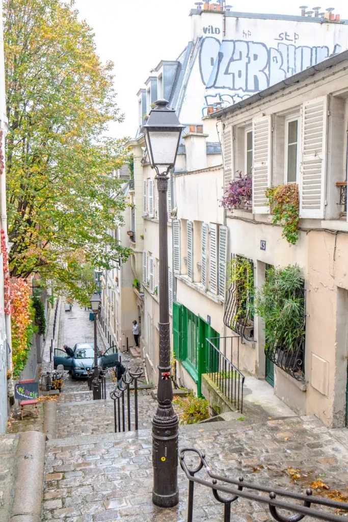 staircase montmartre in the rain with lightpost in the foreground