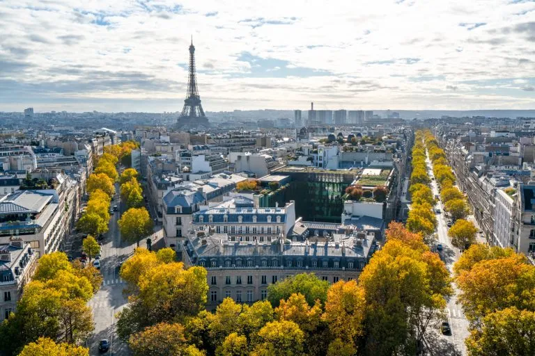 view of the eiffel tower from the arc de triomphe, one of the best views of paris and a cool stop when planning a trip to paris first time