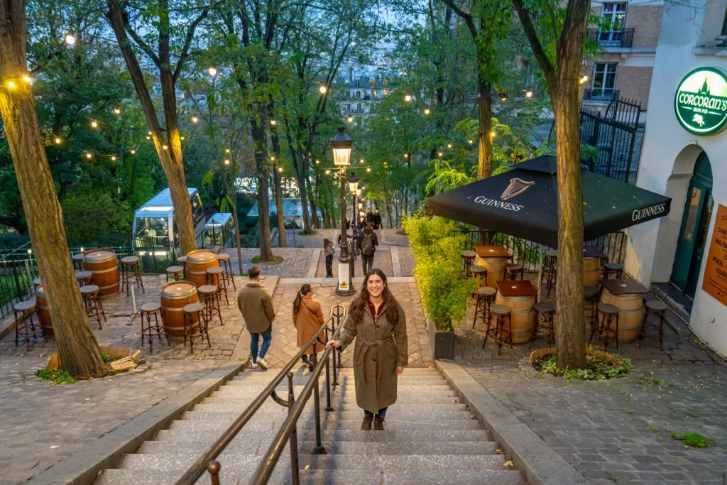 kate storm standing on one of the many staircases in montmartre paris