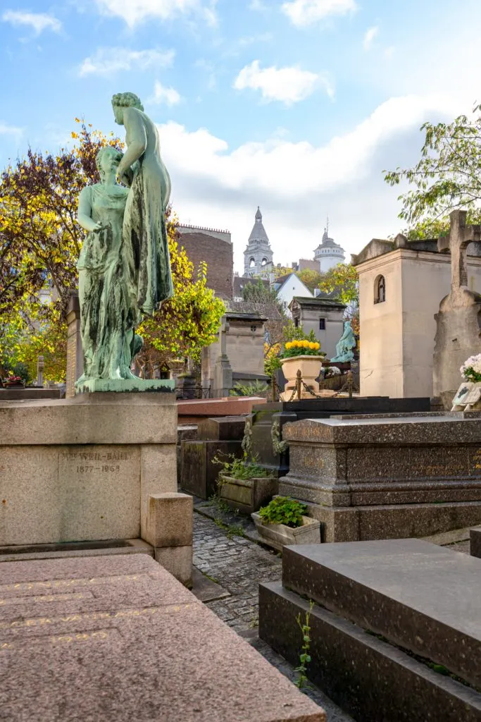 statues and graves in st vincent cemetery as seen on a self guided montmartre walking tour
