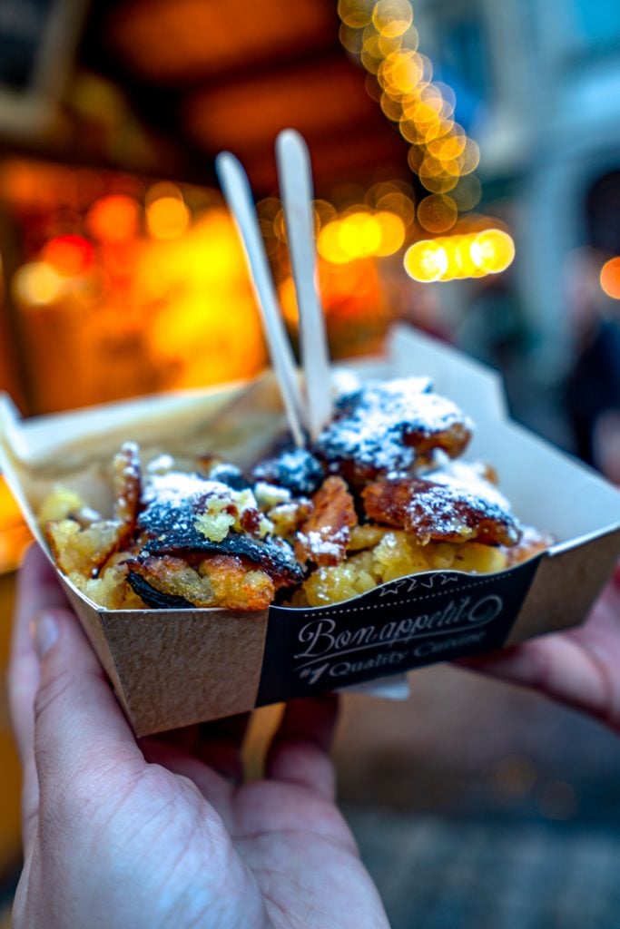 german potato pancake topped with applesauce at a christmas market