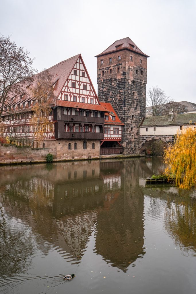 iconic nuremberg viewpoint over the river with reflection showing in the water on a gray winter day