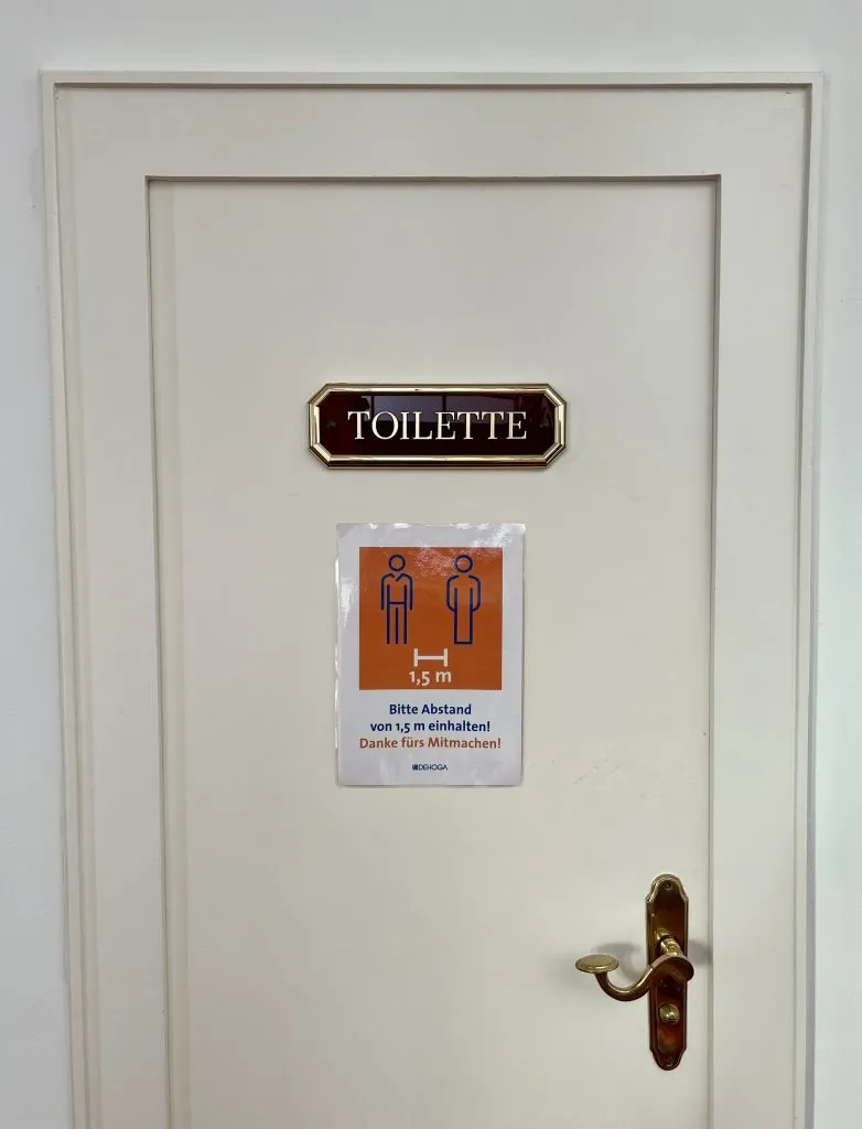 sign for a toilette in a business in europe