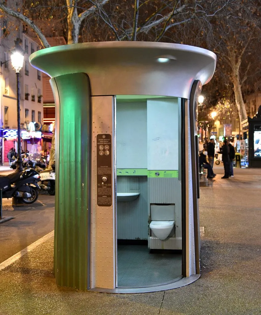 public toilet in europe paris with door open photographed at night