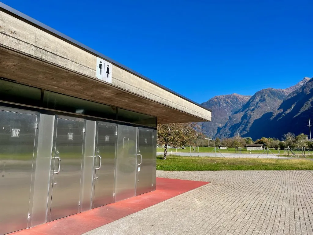 bank of public bathrooms in europe along a highway in switzerland