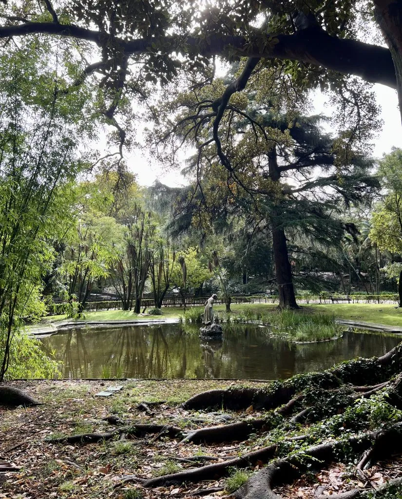 pond with a statue in the center in jardim da estrela garden, one of the most beautiful offbeat places in lisbon