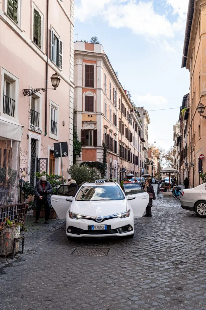 people getting out of a taxi in rome italy, a great way to get off the beaten path in rome