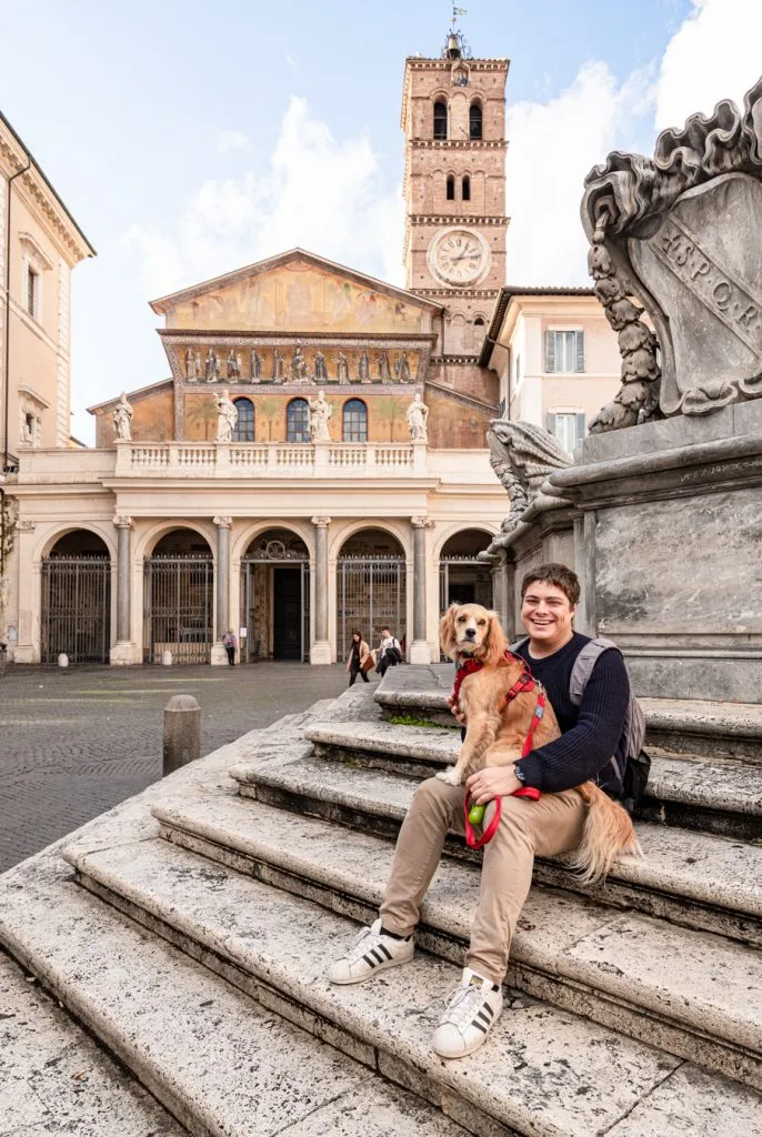 jeremy storm and ranger storm sitting in piazza di santa maria in trastevere rome, one of the best squares in rome italy
