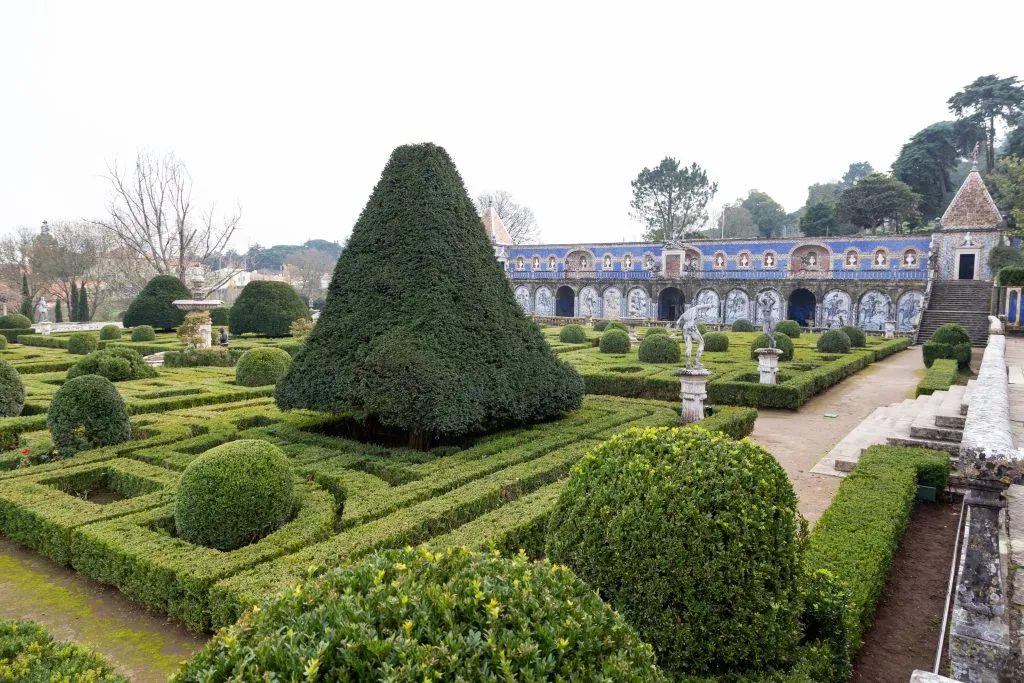 gardens of fronteira palace with azulejos in the background, one of the best lisbon secret spots to visit