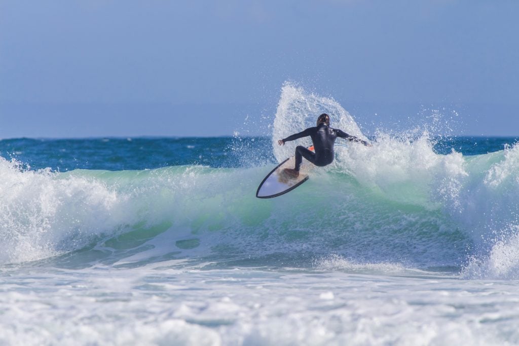 surfer riding a wave at carcavelos beach near lisbon portugal