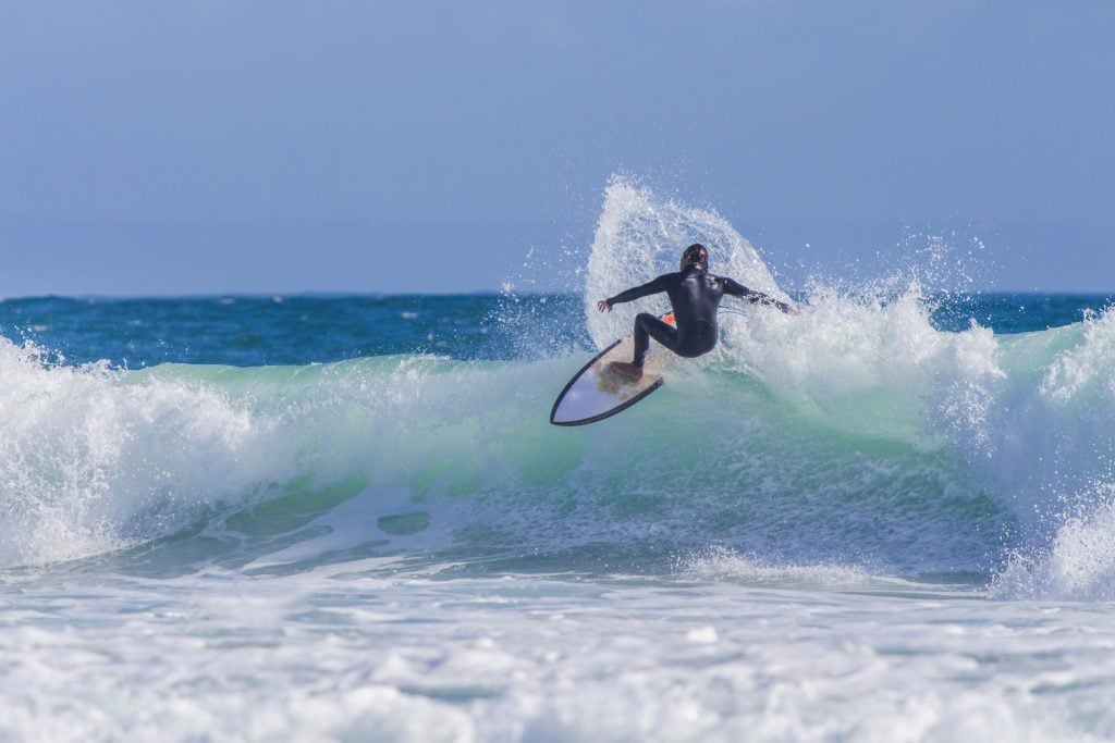 surfer riding a wave at carcavelos beach near lisbon portugal