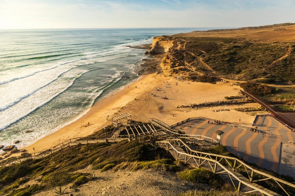 ericeira beach from above at sunset with steps leading to the sand