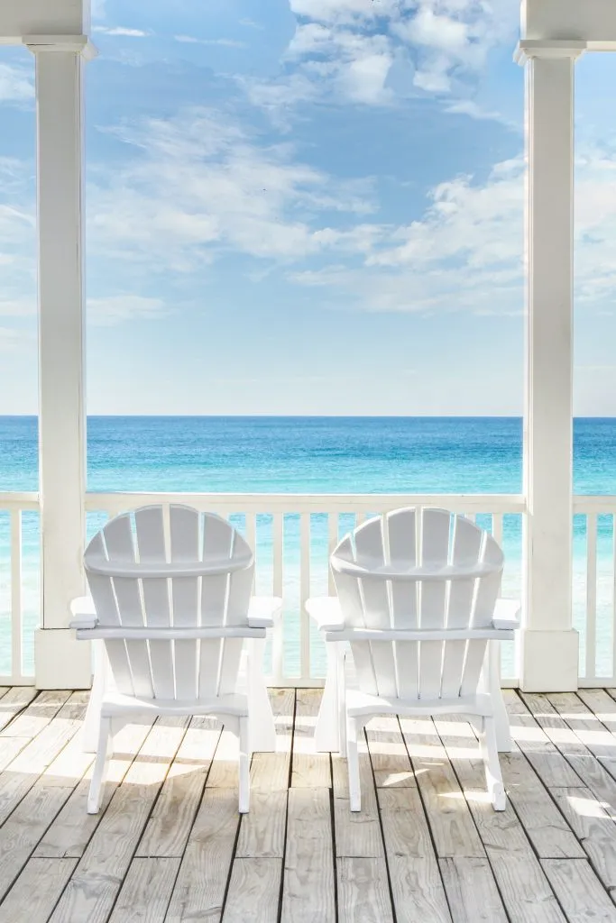 2 white adriondack chairs overlooking the beach at 30a florida summer vacation usa