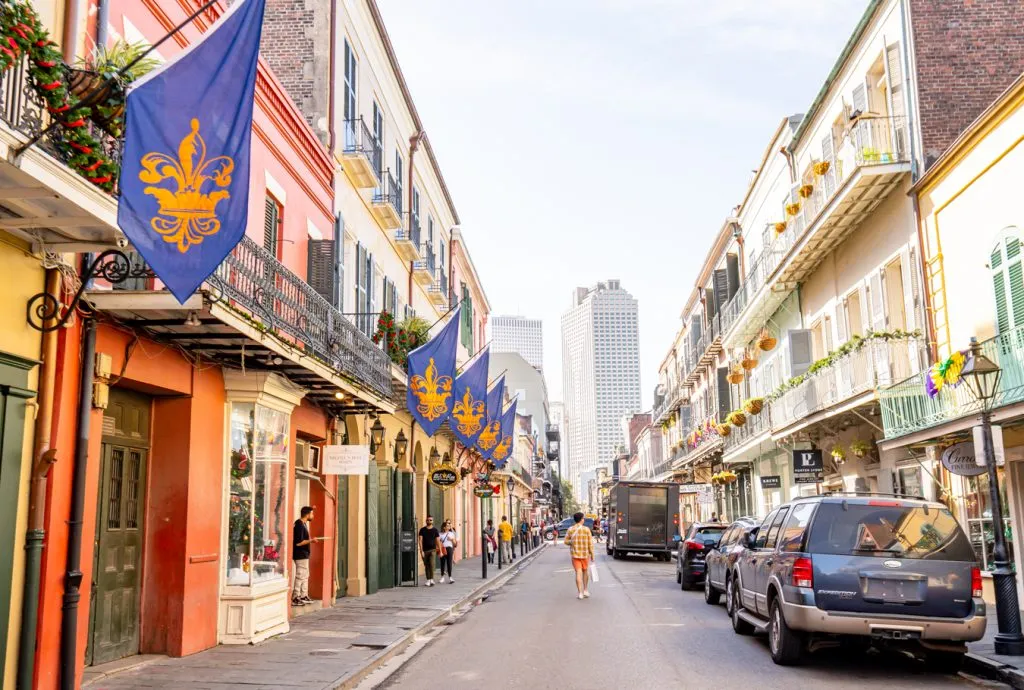 colorful street in new orleans with a blue flag on the left of the photo