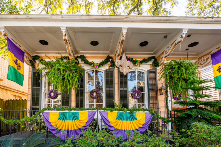 front facade of a new orleans garden district home decorated for mardi gras in nola in january