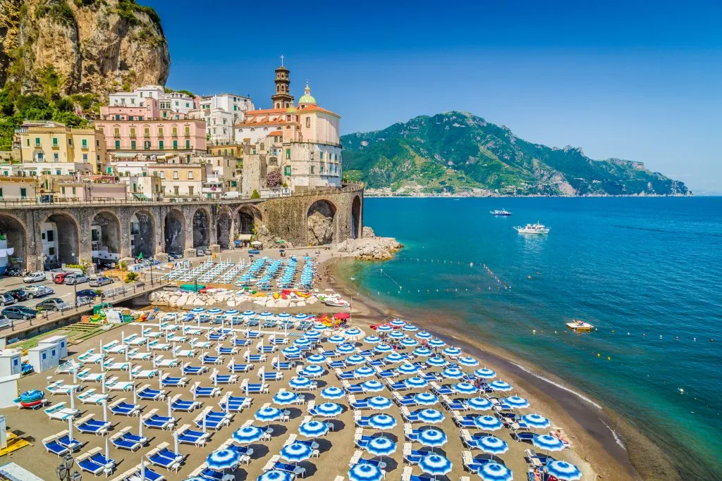 matching colorful umbrellas at italian lido beach clubs on the amalfi coast