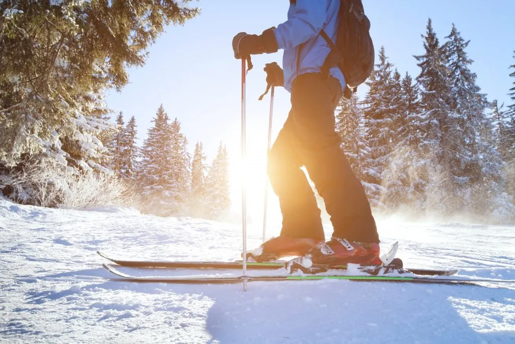 close up of a person on skis in the snow in one of the many colorado ski towns