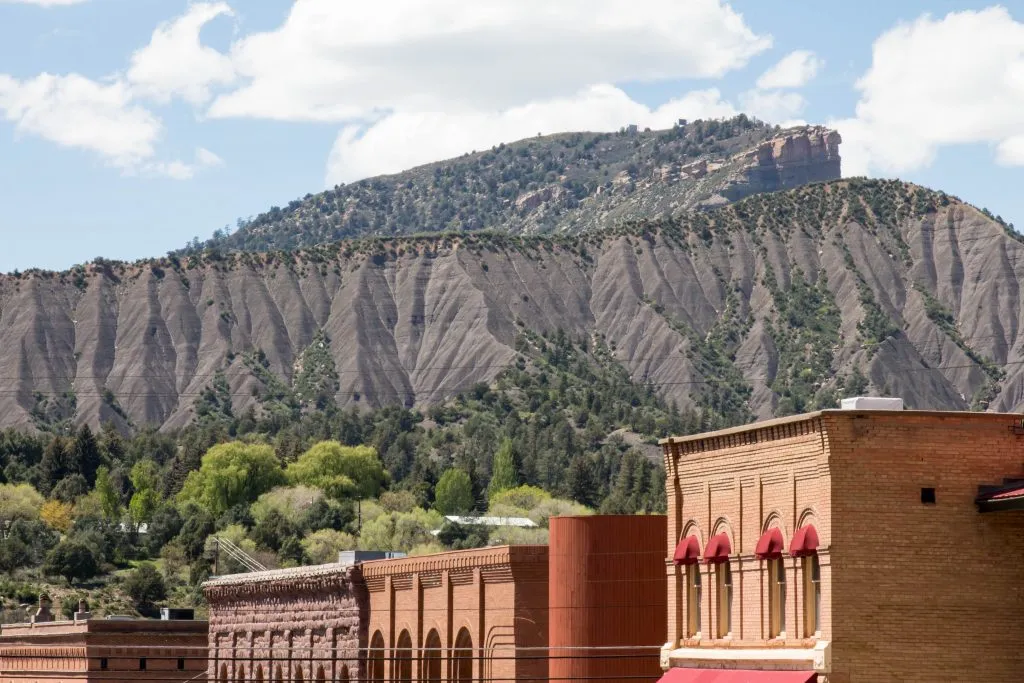 rooftops of durango colorado with mountains in the background, one of the prettiest mountain towns in colorado