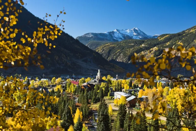view of silverton colorado from above with fall foliage in the foreground, one of the best mountain towns in colorado