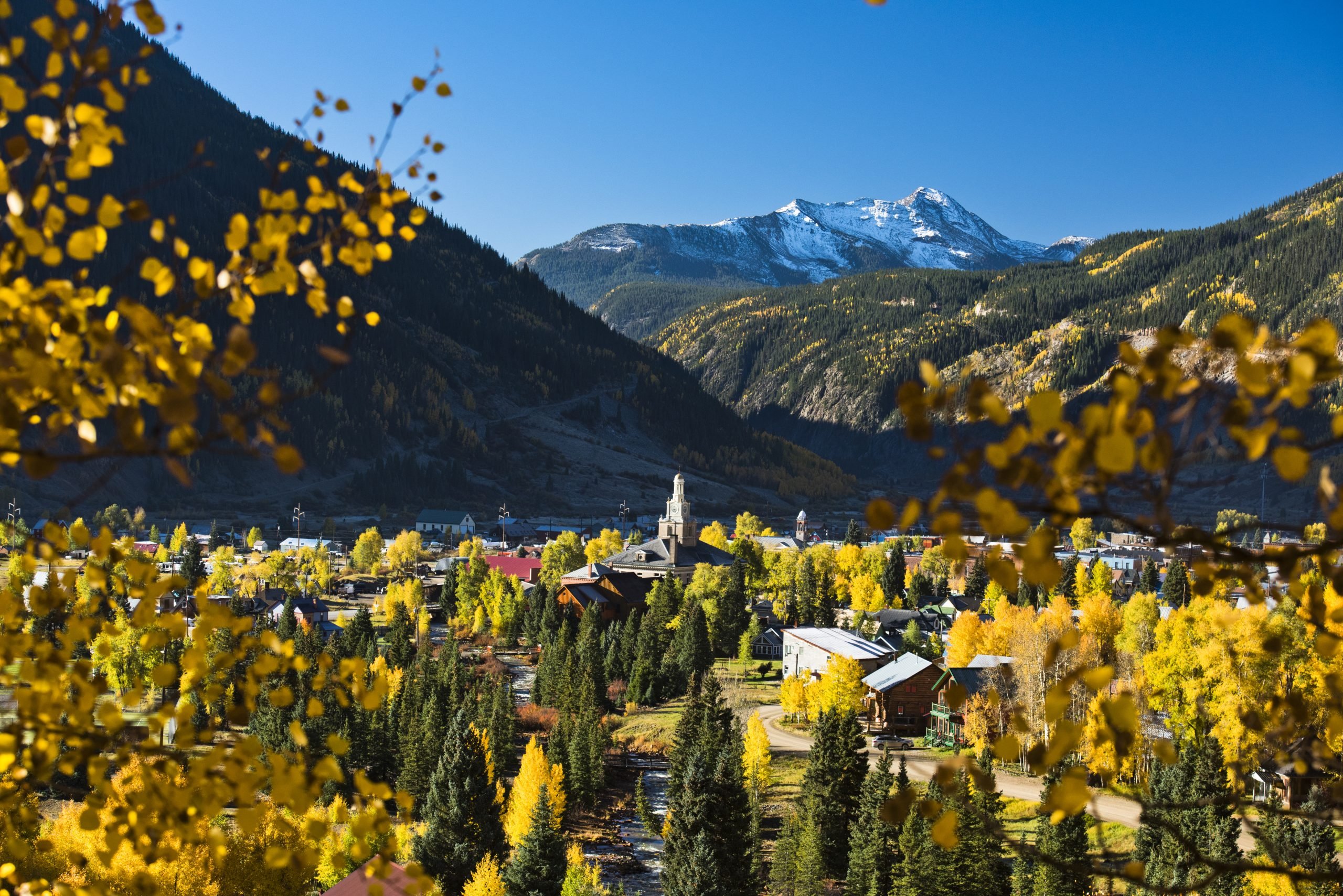 view of silverton colorado from above with fall foliage in the foreground, one of the best mountain towns in colorado