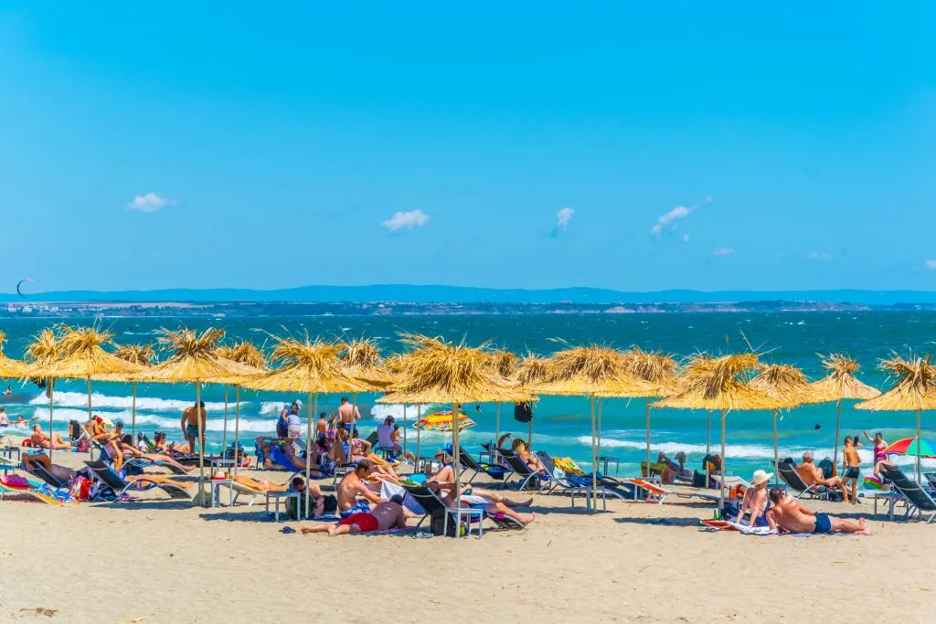 beach filled with visitors and umbrellas in burgas bulgaria, one of the best european coastal cities