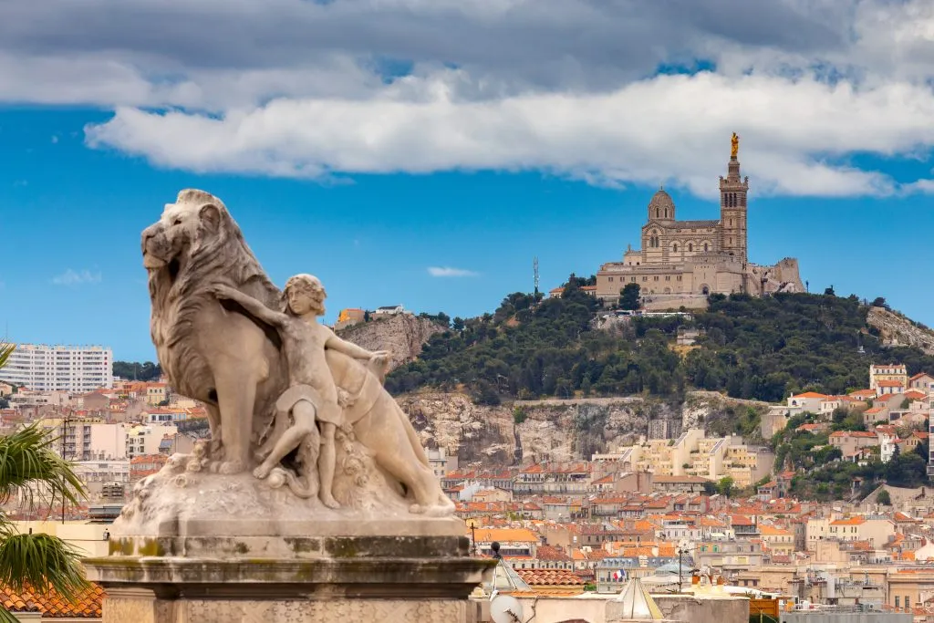 marseille france skyline with statue in foreground and notre dame in background