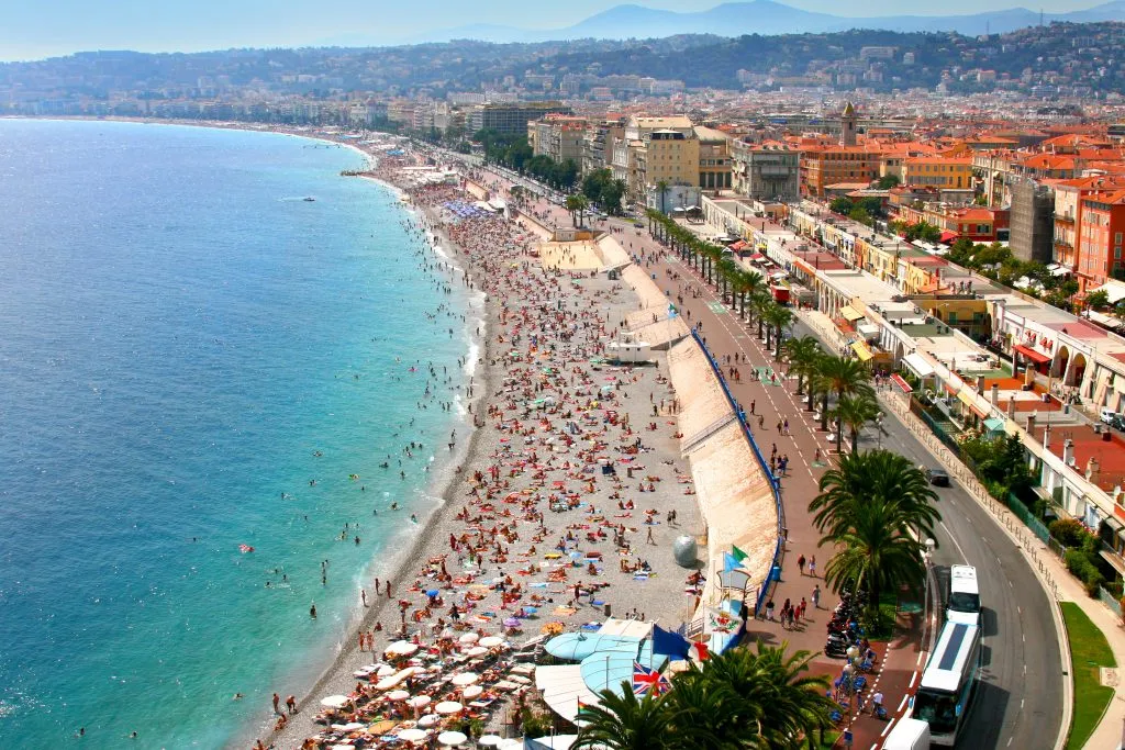 view of nice from from above with bay on the left and beach crowded with visitors