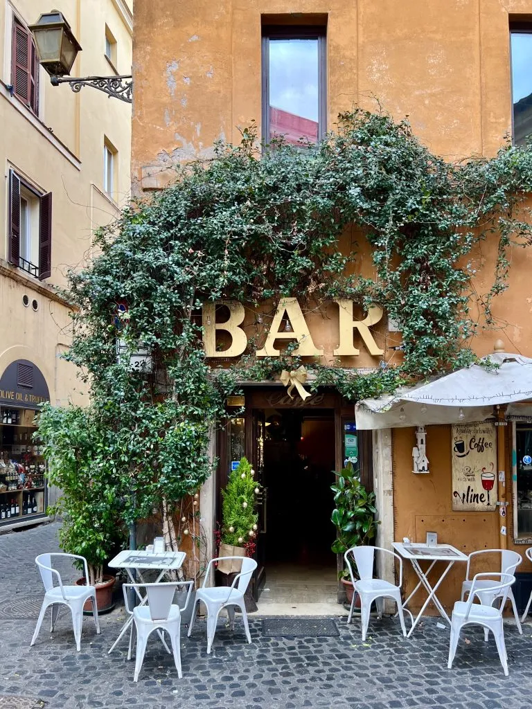 picturesque bar covered in ivy on one of the prettiest streets in trastevere rome