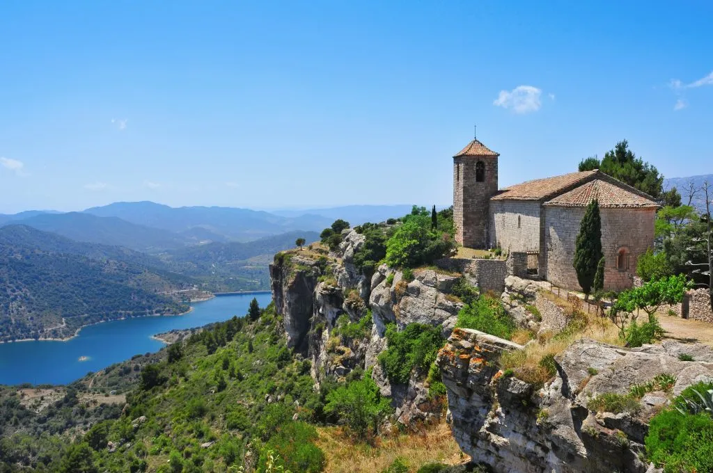 santa maria de siurana church overlooking a cliff, one of the offbeat places to visit near barcelona
