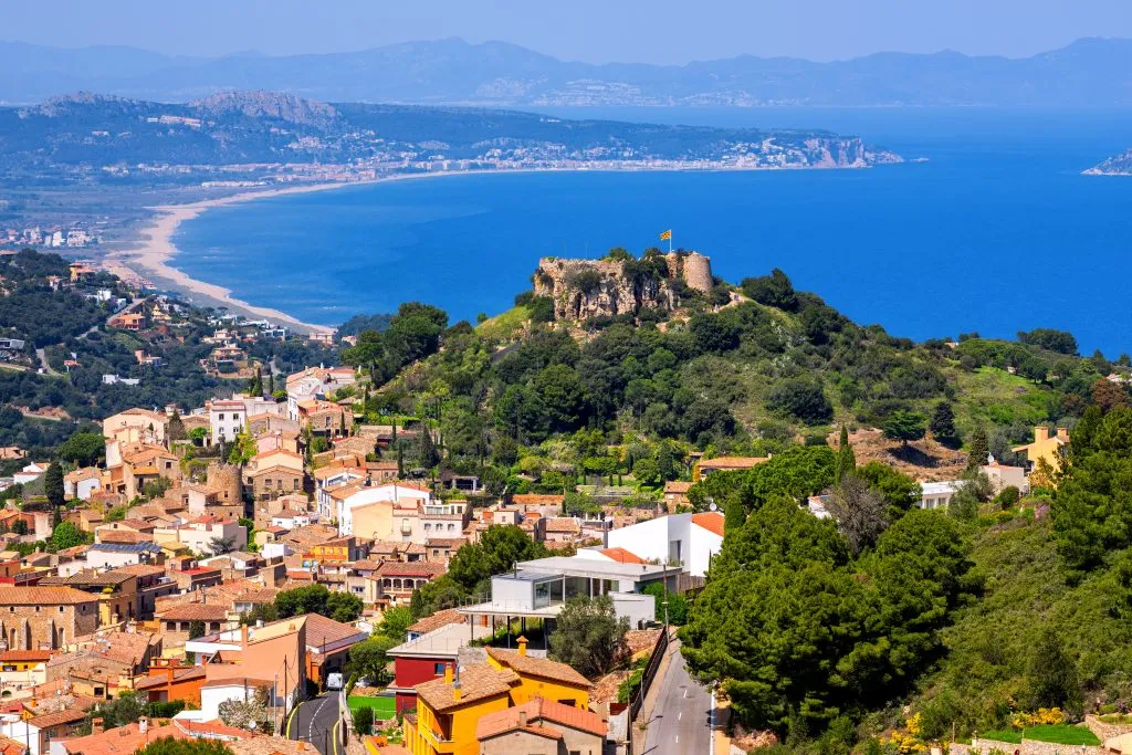 begur spain as seen from above with the mediterranean sea in the distance, one of the best day trips from barcelona spain