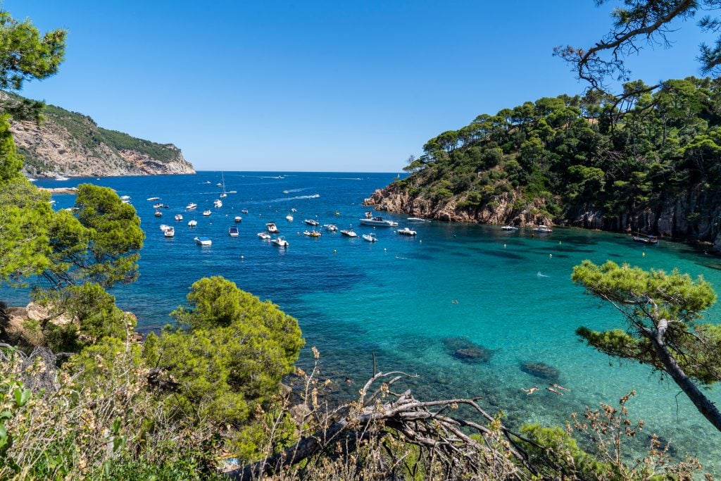 boats floating in a small harbor near an inlet in begur spain