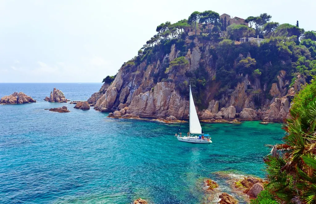 boat sailing along the costa brava, one of the prettiest places to visit near barcelona spain