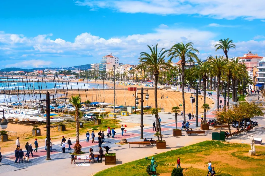 view of the promenade and beach in sitges spain, one of the best beach towns near barcelona easiest day trips