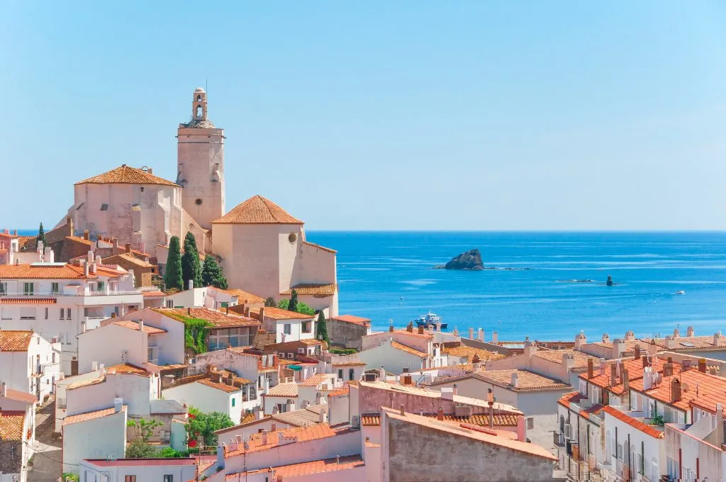 rooftops of cadaques catalonia spain with mediterranean sea visible in the distance