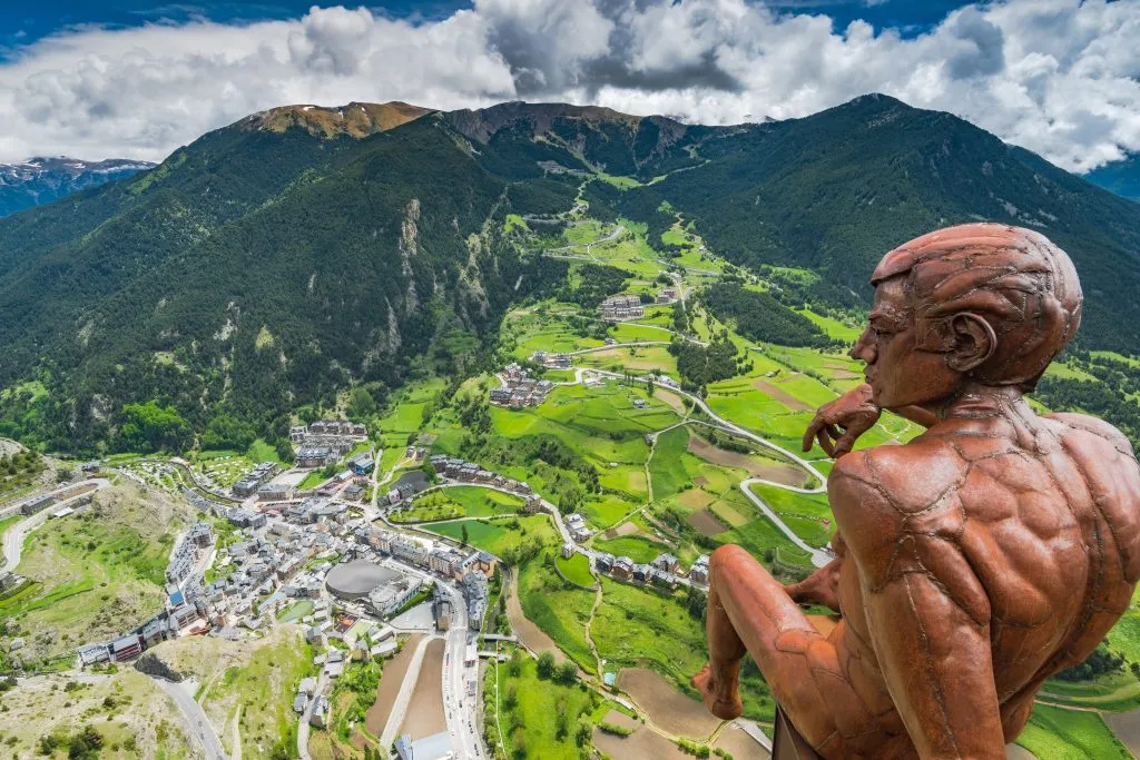 view from roc del quer observation deck in andorra with statue of bronze man in foreground