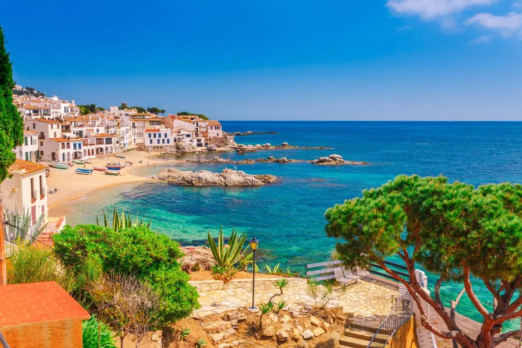 view of Calella de Palafrugell from the coast with mediterranean sea in the foreground