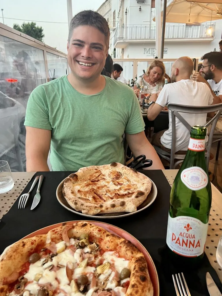 jeremy storm with 2 italian pizzas in front of him when eating italy pizza