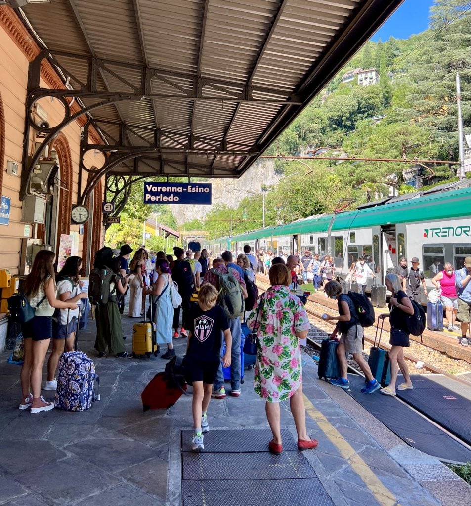 crowded train platform in varenna italy, a common stop on a day trip to lake como from milan italy